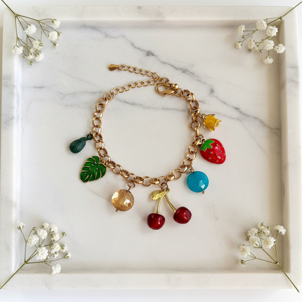 Gold Fruit Nature Charm Bracelet flat lay on marble tray