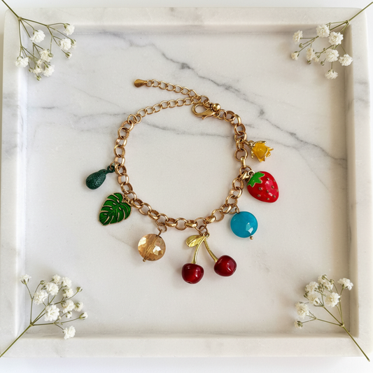 Gold Fruit Nature Charm Bracelet flat lay on marble tray
