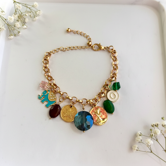 Gold Elephant Coin Charm Bracelet flat lay on marble tray