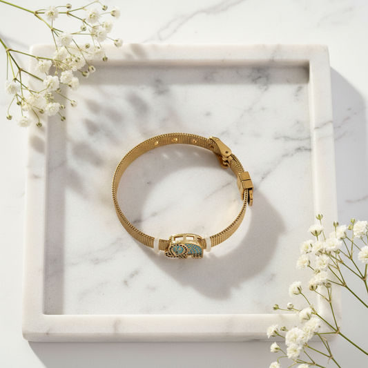 Gold Elephant Bracelet flat lay on marble tray