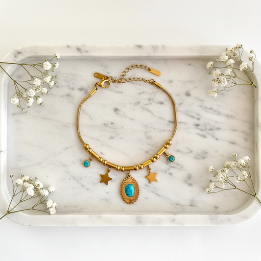 Gold Turquoise Star Bracelet flat lay on marble tray