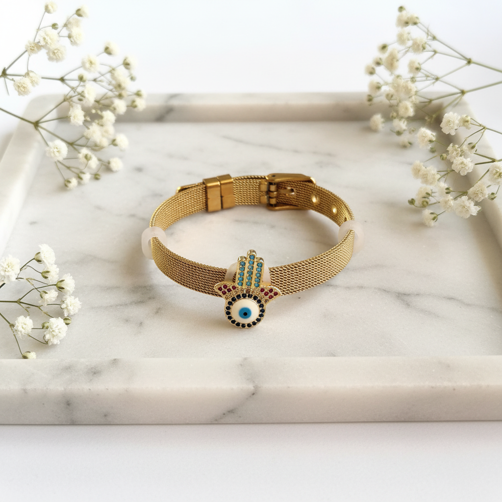 Gold Hamsa Evil Eye Bracelet flat lay on marble tray