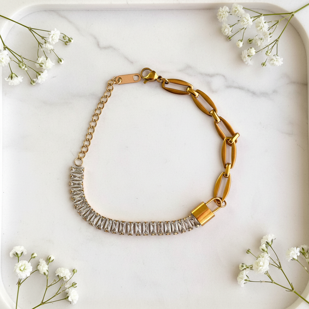 Gold Baguette Padlock Chain Bracelet flat lay on marble tray
