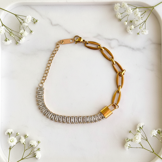 Gold Baguette Padlock Chain Bracelet flat lay on marble tray