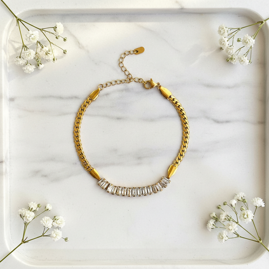 Gold Snake Baguette Crystal Bracelet flat lay on marble tray